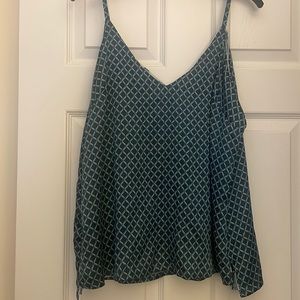 Never been worn camisole. It’s reversible.Beautiful shades of blue.